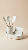 A centered image of a ceramic kitchen organizer from Urban Oasis, set against a light beige background. The product's...